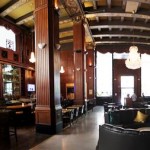 The cavernous interioir of The Federal Bar, Long Beach. Towering columns, wood paneling, and chandeliers add to the ambience.