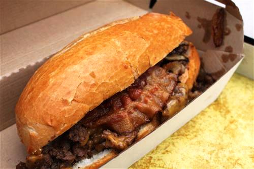 Bacon Cheese Steak Sandwich: Angus rib-eye topped with carmelized onions, bacon, and cheddar cheese.