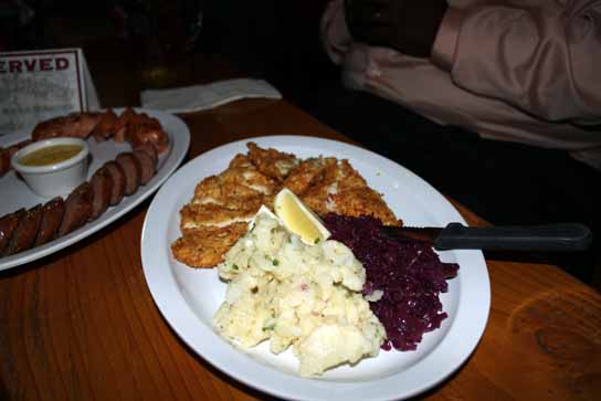 Chicken schnitzel served with German potato salad and stewed red cabbage