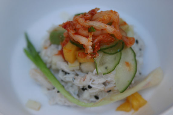 Coconut crab topped with thinly sliced cucumber, avocado, mango and kimchi