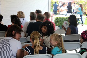 Arti Sequeira gives some attention to a couple of her young fans at THE TASTE 2011.