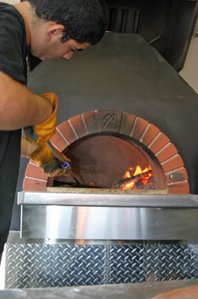 Pizzaiolo making a true Neopolitan wood fired pizza