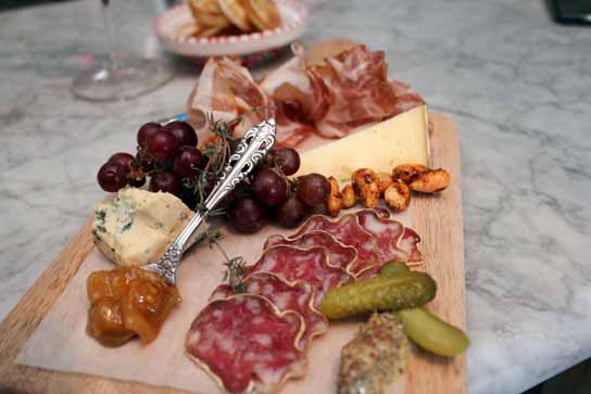 Charcuterie plate with meats, cheeses, and pickles. Almost too pretty to eat!