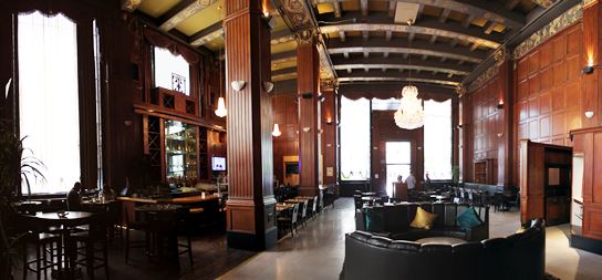 The cavernous interioir of The Federal Bar, Long Beach.  Towering columns, wood paneling, and chandeliers add to the ambience.