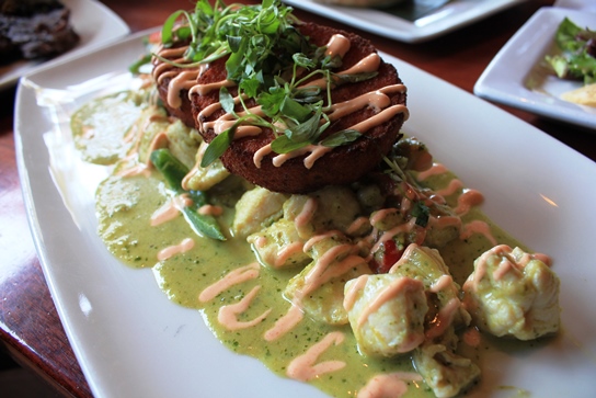 Lazy Dog Chicken Poblano with tamle cakes, a fusion of mexican tamales and polenta cakes.  The impossibly tender chicken and creamy pablano sauce elevate this dish above all others.