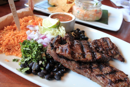 Carne Asada - Premium Angus Skirt Steak grilled to perfection and served with beans, rice, and tortillas.