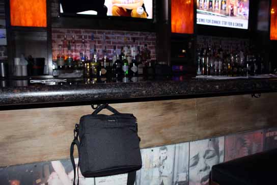 Yes!  Look for hooks under the bar for your purse, murse, or camera bag.