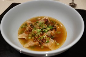 Steamed dumplings in a dipping sauce