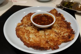 Fried potato pancake with hot chile sauce