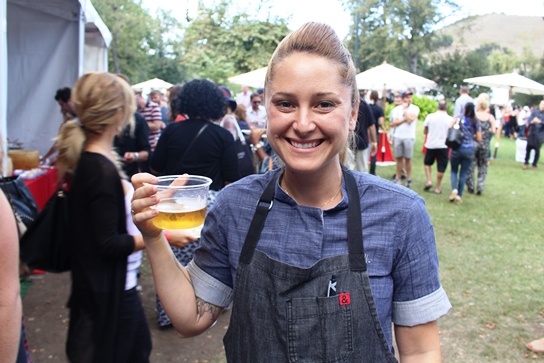 Chef Brooke Williamson cools of with a large sample of beer after heating up the demonstration stage.
