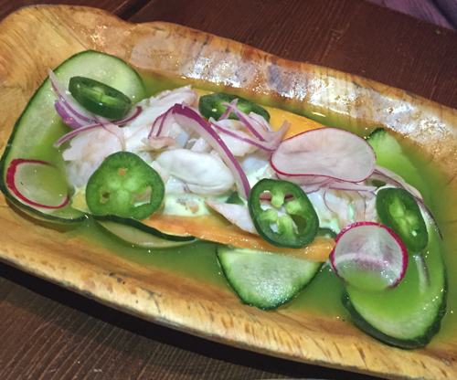 Agua Chile with papaya lime water, red onions, and cucumber chips