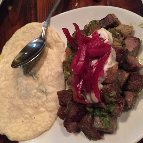 Seared lengua with crispy potatoes, avocado, corn tortillas, tomatillo sauce