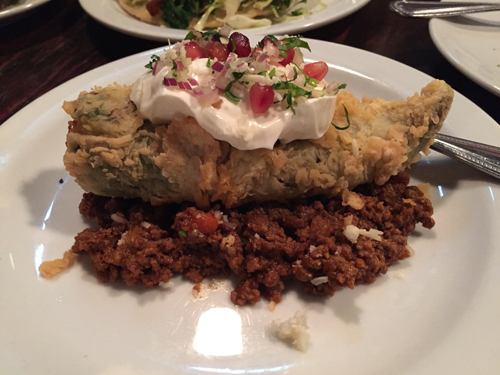 Chile Relleno on top of a bed of picadillo