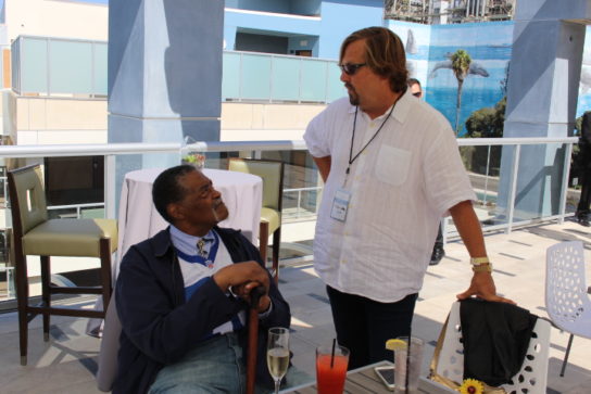 Rams legend Rosey Grier and hotel owner Michael ZIslis share a moment during the party.