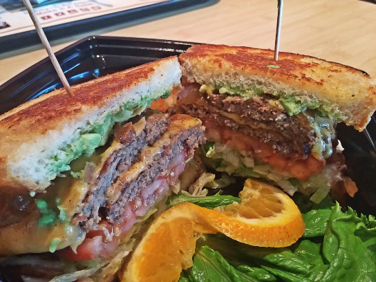 The Santa Barbara style burger adds avocado, cheese, and sourdough bread to the already tasty double char.