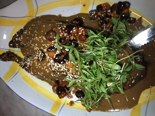 Duck Mole with persimmons topped with sesame seeds