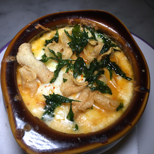 Queso Fundido topped with roasted tomatoes and kale