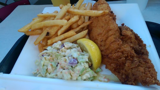 Fried fish plate with fries and coleslaw.