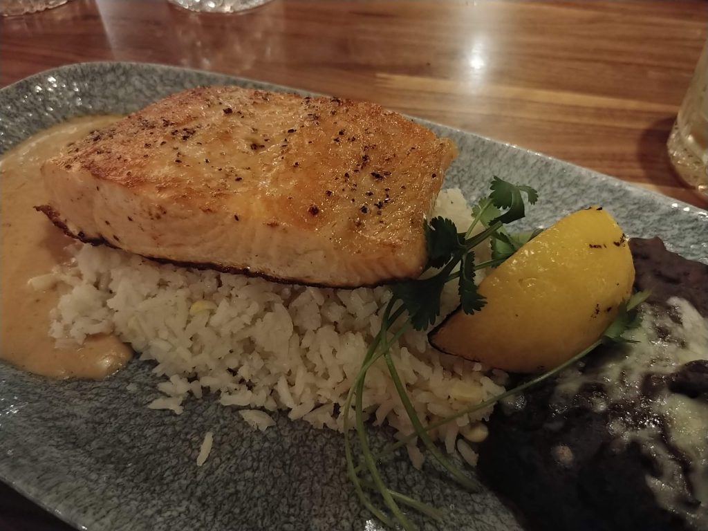 Salmon Asado with white rice, black beans and chipotle flavored lemon butter sauce