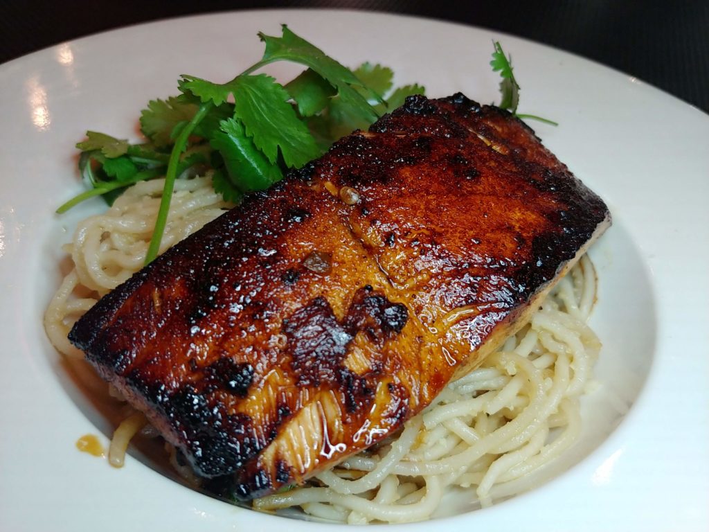 Long Life Garlic Noodles topped with grilled salmon